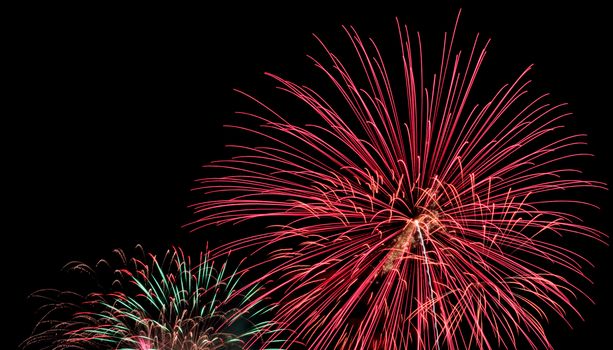 Exposure of multiple fireworks with a black sky.