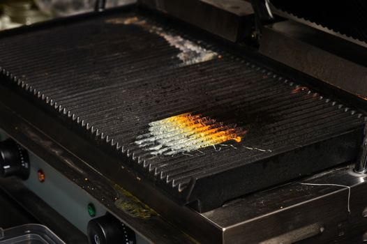 dirty electrical grill in real industrial kitchen