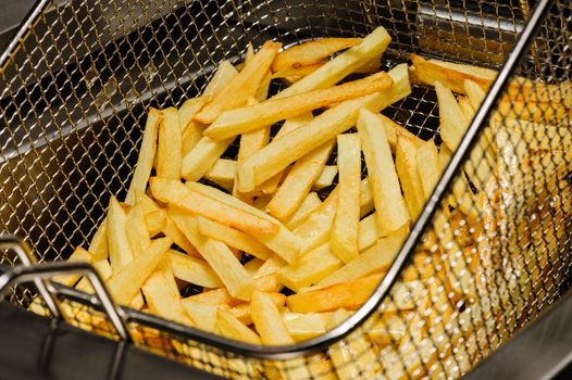 french fries freshly cooked in electric fryer