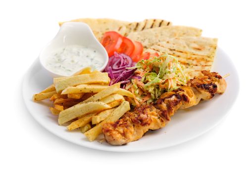 one portion of french fries, chicken kebab, salad and roasted pita