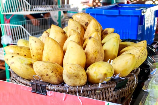 Mangoes in a basket on the market.