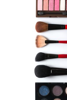 makeup brush and cosmetics, on a white background isolated