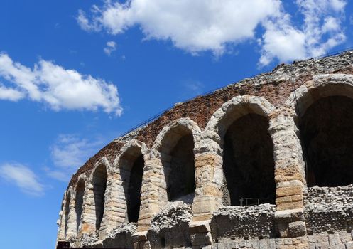 Side view of arches and details of famous ancient roman amphitheatre Arena di Verona in a sunny day with blue sky, Italy, Europe.