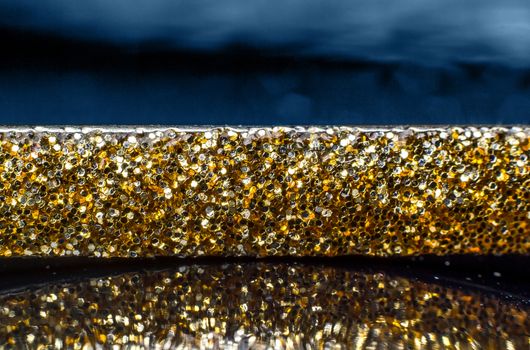 Gold tiara with reflections and blue background