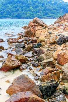 Rocky beach and surf with the sea.