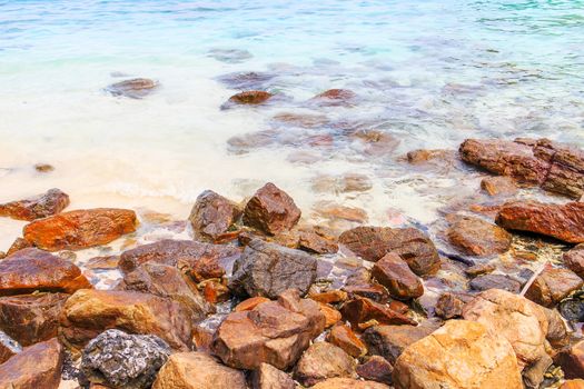 Rocky beach and surf with the sea.