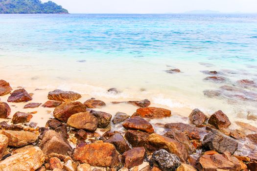 Rocky beach and surf with the sea.