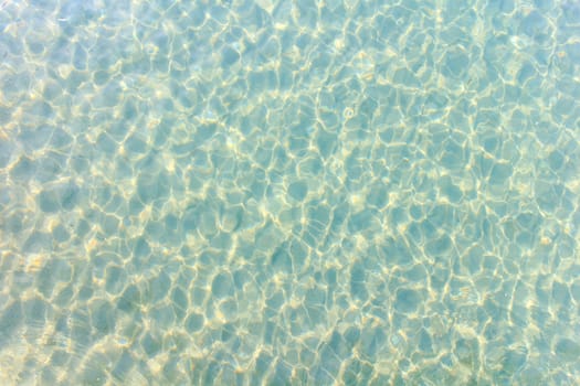 Water ripples in the blue sea water.