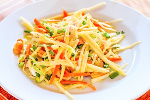 A spicy mango salad with vegetable and chili.