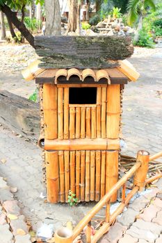 A wooden public trash in the garden center.