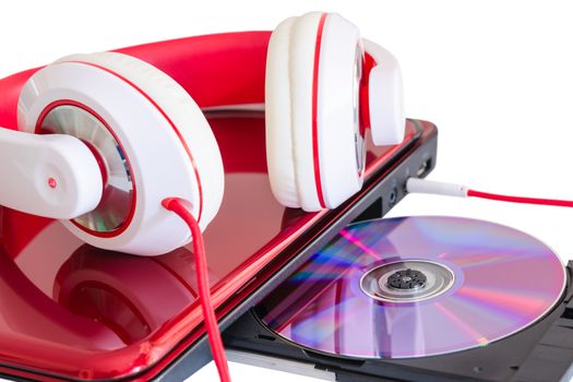 Red headphones and laptop with compact disk for language course learning