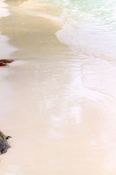 Soft wave of the sea on the sandy beach.