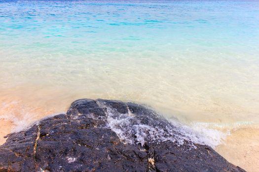 Soft wave of the sea on the sandy beach.