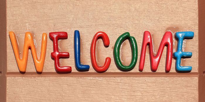 colorful of the welcome word on brown plate