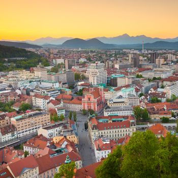 Panorama of the Slovenian capital Ljubljana at sunset. Alps mountains