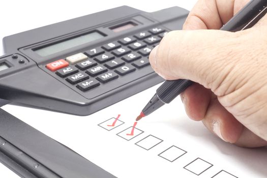 human hand drawing red check mark in checklist box