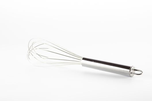 kitchen tools egg whisk on a white background
