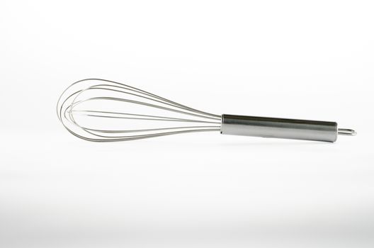kitchen tools egg whisk on a white background