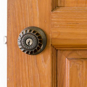 door knob and key hold on wood