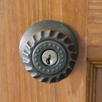 door knob and key hold on wood