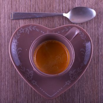 Coffee cup with heart shaped plate, from above