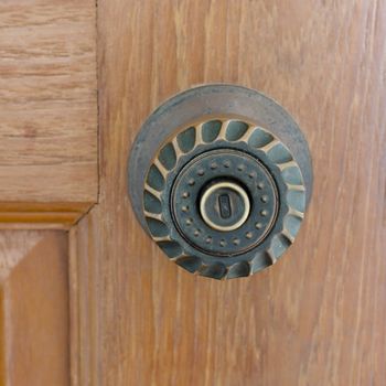 door knob and key hold on wood