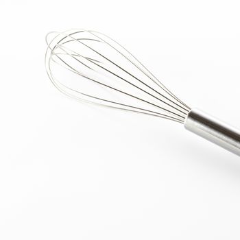 kitchen tools egg whisk on a white background