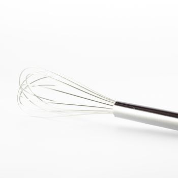 kitchen tools egg whisk on a white background