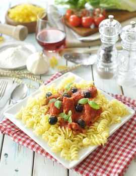 Italian pasta dish with tomato sauce and basil 