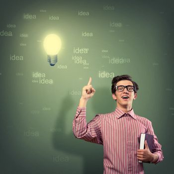 young man holding a book in front of him, raised his hand, the idea