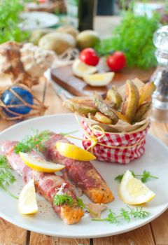 Bacon wrapped salmon fillets with fried potato wedges