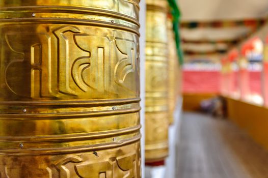 Prayer wheels of Lharong Monastery in Sertar, Tibet.  Lharong Monastery is a Tibetan Buddhist Institute at an elevation of about 4000 meters.