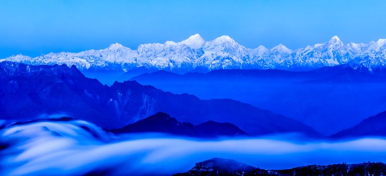 Minya Konka snow mountain with the clouds sea under the sunrise in Niubei mountain of Sichuan province of China.