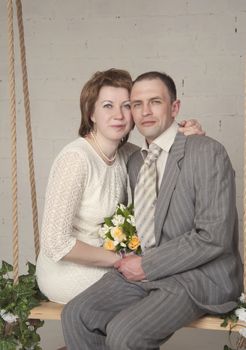 bride and groom are swinging in the Studio