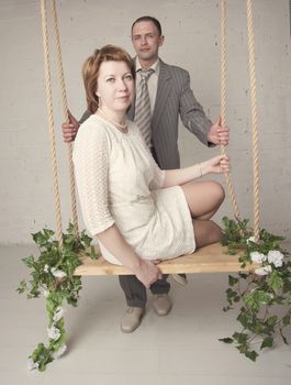 bride and groom are swinging in the Studio