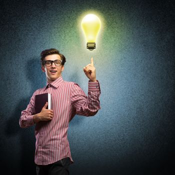 young man holding a book in front of him, raised his hand, the idea