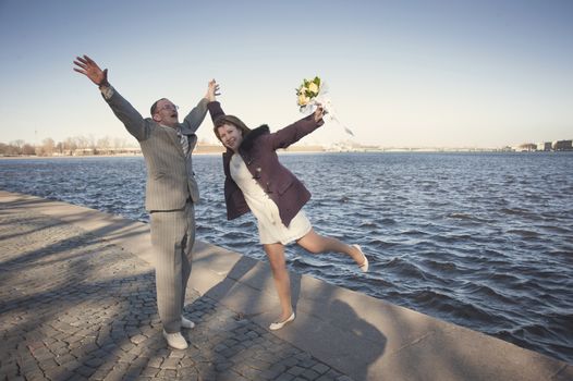 couple walk along the embankment of the river