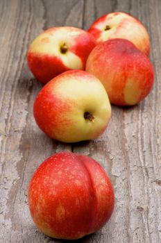 Heap of Perfect Ripe Nectarines on Rustic Wooden background