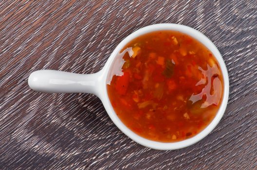 Sweet and Sour Sauce in White Sauce Gravy isolated on Wooden background. Top View