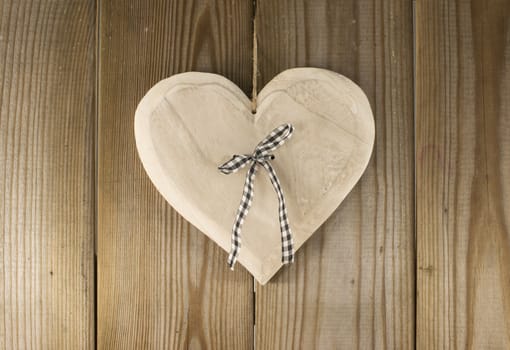 hanging valentines heart shape on wooden backkground