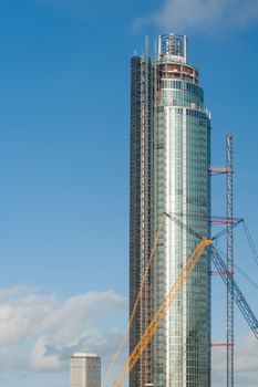 London, UK - January 27, 2013: Repairs being made to the construction crane on The Tower recently hit by a helicopter at St George Wharf, London, UK