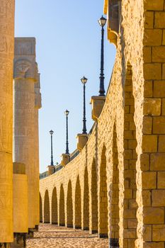 The arched stone colonnade with suspended lanterns