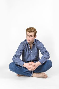 portrait of cool boy with red hair posing in studio