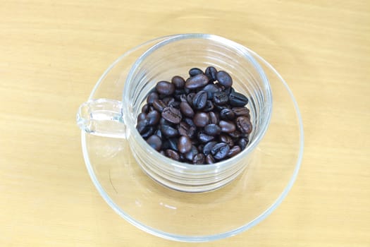 coffee beans in cup on the wood table