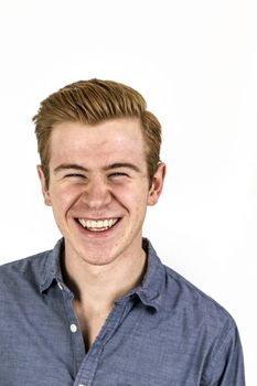 portrait of cool boy with red hair posing in studio