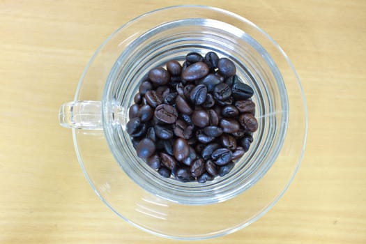 coffee beans in cup on the wood table