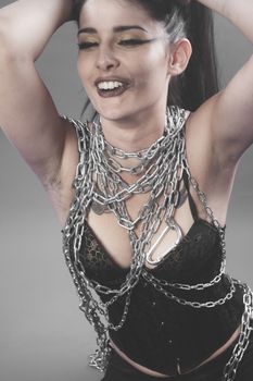 Fetish, Beautiful brunette woman with big silver chains chained