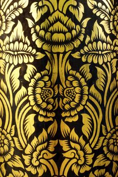 detail of thai pattern that made by covered wood plate with gold leaf for decorated temple door or pillar,shallow focus