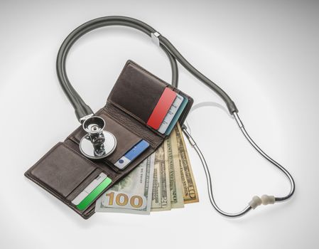 Stethoscope taking the pulse of your wallet to see if there is enough money to pay the bills