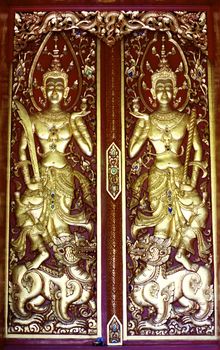 detail of wood carving with thai pattern on natural wood plate for decorated temple,Thailand